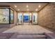 Modern front entrance with a large wood pivot door, stacked stone accents, and gorgeous lighting at 26885 N 87Th Dr, Peoria, AZ 85383