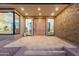 Stunning front entrance featuring a large pivot door, stacked stone accents, and luxury finishes at 26885 N 87Th Dr, Peoria, AZ 85383