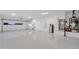 Spacious garage with epoxy flooring, ample storage, and modern lighting at 26885 N 87Th Dr, Peoria, AZ 85383