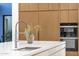 Kitchen island with stainless steel faucet and built-in oven at 26885 N 87Th Dr, Peoria, AZ 85383