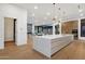 Open-concept kitchen with large island flowing into the living area at 26885 N 87Th Dr, Peoria, AZ 85383