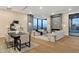 Open-concept living room with modern furnishings, fireplace, and mountain views at 26885 N 87Th Dr, Peoria, AZ 85383