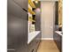 Pantry with dark cabinets, yellow shelving, and ample storage space at 26885 N 87Th Dr, Peoria, AZ 85383