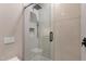 Modern shower with glass door, sleek fixtures, and mosaic tile accents at 26885 N 87Th Dr, Peoria, AZ 85383