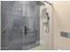 Modern shower featuring sleek gray tile, black fixtures, and a convenient built-in niche at 26885 N 87Th Dr, Peoria, AZ 85383