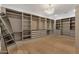 Spacious walk-in closet with custom shelving, drawers, and ample storage space at 26885 N 87Th Dr, Peoria, AZ 85383