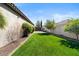Well-maintained backyard with green lawn, mature landscaping and privacy fence at 27016 N 20Th Ln, Phoenix, AZ 85085