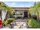 Charming backyard with a covered patio, beautiful desert landscaping, mature palm trees, and an outdoor seating area at 27016 N 20Th Ln, Phoenix, AZ 85085