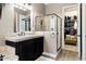 Elegant bathroom with a walk-in glass shower, soaking tub, and open closet at 27016 N 20Th Ln, Phoenix, AZ 85085