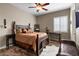 Bedroom with decorative bed and dark wood floors, a window and seating space to the right at 27016 N 20Th Ln, Phoenix, AZ 85085