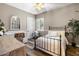 Bedroom featuring dark wood floors, an iron bed, large window and a corner seating area at 27016 N 20Th Ln, Phoenix, AZ 85085