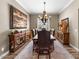 Formal dining room with chandelier, decorative wood furniture and elegant area rug at 27016 N 20Th Ln, Phoenix, AZ 85085