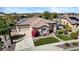 Inviting single-story home featuring desert landscaping, a tiled roof, and a two-car garage at 27016 N 20Th Ln, Phoenix, AZ 85085