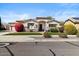 Inviting single-story home featuring desert landscaping, stone accents, and a covered entryway at 27016 N 20Th Ln, Phoenix, AZ 85085