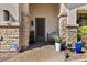 The home features a beautifully adorned front entryway with stone pillars and a decorative metal door at 27016 N 20Th Ln, Phoenix, AZ 85085