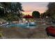 Tranquil backyard pool and spa area with lush landscaping and ambient lighting at sunset at 27016 N 20Th Ln, Phoenix, AZ 85085