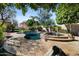 Beautiful backyard pool with mature landscaping, a built-in spa, rock waterfalls, poolside seating, and shade trees at 27016 N 20Th Ln, Phoenix, AZ 85085