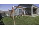 Spacious backyard with artificial turf, swing set, patio, and pool views perfect for outdoor entertainment at 281 S San Gregorio Ln, Casa Grande, AZ 85194