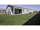 Expansive backyard featuring artificial turf, covered patio with outdoor seating, and a lush, green lawn at 281 S San Gregorio Ln, Casa Grande, AZ 85194