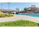 Community pool featuring a large slide, inviting seating, and manicured landscaping for Gathering enjoyment at 281 S San Gregorio Ln, Casa Grande, AZ 85194
