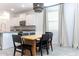 Dining area with modern lighting, chairs and view of kitchen, fostering gathering at 281 S San Gregorio Ln, Casa Grande, AZ 85194