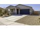 Charming single-story home with a well-maintained lawn and a two-car garage and stone veneer at 281 S San Gregorio Ln, Casa Grande, AZ 85194