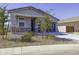 Well-maintained single-story home with a tidy front yard, rock landscaping and a dark two-car garage at 281 S San Gregorio Ln, Casa Grande, AZ 85194