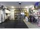 Well-organized garage with storage shelves, weight equipment, and ample space for a home gym at 281 S San Gregorio Ln, Casa Grande, AZ 85194