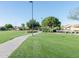 Well-maintained community green space with walking paths, mature trees and lush grass at 281 S San Gregorio Ln, Casa Grande, AZ 85194