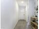 Bright hallway with neutral tile floors, leading to a white front door and other rooms of the house at 281 S San Gregorio Ln, Casa Grande, AZ 85194