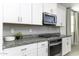 A sleek kitchen shows granite countertops, stainless oven, and white cabinets at 281 S San Gregorio Ln, Casa Grande, AZ 85194
