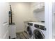Bright laundry room features modern appliances, folding area, and ample storage at 281 S San Gregorio Ln, Casa Grande, AZ 85194