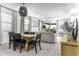 Open-concept living room with tile flooring, dining table, and natural light at 281 S San Gregorio Ln, Casa Grande, AZ 85194