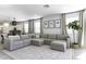 Open-concept living space featuring a sectional sofa, modern decor, and bright natural light at 281 S San Gregorio Ln, Casa Grande, AZ 85194