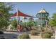 View of a community playground with slides, climbing walls, and shade structure at 281 S San Gregorio Ln, Casa Grande, AZ 85194