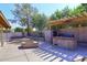 Outdoor kitchen including a grill and smoker, surrounded by block wall fencing at 2901 W Straford Dr, Chandler, AZ 85224
