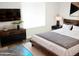 Bedroom features modern decor, including a black dresser and sleek wooden bed frame at 2901 W Straford Dr, Chandler, AZ 85224