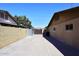 Long driveway leading to a gate, with ample space for parking and storage at 2901 W Straford Dr, Chandler, AZ 85224