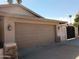 Attached two car garage with traditional doors, stone accents, and carriage lights at 2901 W Straford Dr, Chandler, AZ 85224