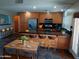 An open kitchen features stainless steel appliances, an eat-in island, and wood cabinets at 2901 W Straford Dr, Chandler, AZ 85224