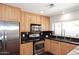 Close-up of the bright kitchen with stainless steel appliances and dark granite countertops at 2901 W Straford Dr, Chandler, AZ 85224