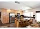 Bright kitchen with stainless steel appliances, wooden cabinets and a center island with bar seating at 2901 W Straford Dr, Chandler, AZ 85224