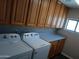 Laundry room with Whirlpool appliances, upper cabinets and long countertop at 2901 W Straford Dr, Chandler, AZ 85224