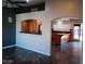Open-concept living space with slate-style floors offering views into the kitchen with wooden cabinets at 2901 W Straford Dr, Chandler, AZ 85224