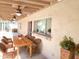 A covered patio features ceiling fans and a wooden table surrounded by wicker chairs at 2901 W Straford Dr, Chandler, AZ 85224