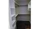 Walk-in closet with white shelving, creating an organized space, and the unique tile flooring at 2901 W Straford Dr, Chandler, AZ 85224
