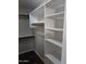 Walk-in closet with white shelving, creating an organized space, and the unique tile flooring at 2901 W Straford Dr, Chandler, AZ 85224