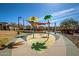 Community splash pad with colorful features, shade structure and desert landscaping at 3002 N Sonoran Hls, Mesa, AZ 85207