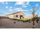 Exterior shot of home's backyard shows desert landscaping, artificial turf, and privacy fence at 35961 W San Ildefanso Ave, Maricopa, AZ 85138