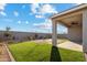Sprawling backyard shows well-kept artificial turf, desert landscaping, and a covered patio at 35961 W San Ildefanso Ave, Maricopa, AZ 85138
